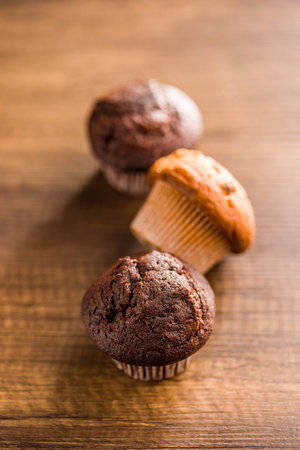 Sweet muffin cakes on a wooden table.の写真素材