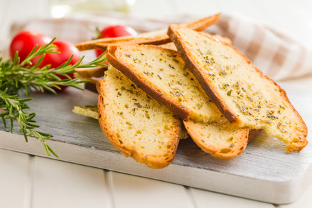 Crispy roasted bruschetta bread on a cutting board.の写真素材