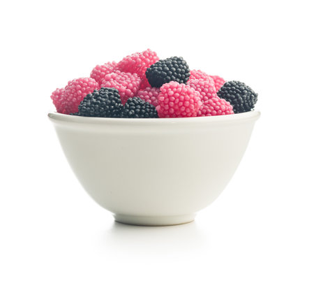 Sweet jelly candies in a bowl isolated on a white background.の写真素材
