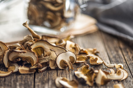Dried porcini mushrooms. Sliced boletus on a wooden table.の写真素材