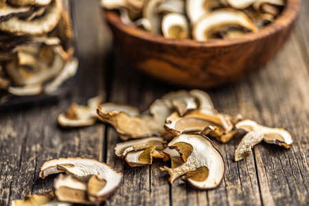 Dried porcini mushrooms. Sliced boletus on a wooden table.の写真素材