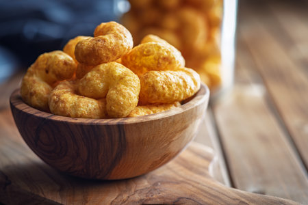 Puffed crispy Peanut flips in a bowl on a wooden table.の写真素材
