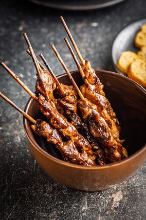 Japanese chicken yakitori in bowl on a black table.の写真素材
