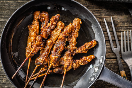 Japanese chicken yakitori on pan on a wooden table. Top view.の写真素材