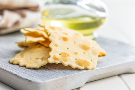 A crispy salted crackers on a white cutting board.の写真素材