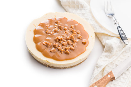 Cheesecake with caramel topping isolated on a white background.の写真素材