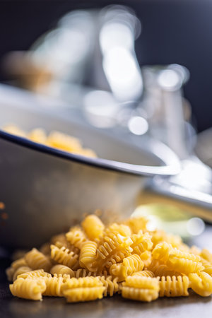 Uncooked italian pasta. Radiatori pasta on a black table.の写真素材