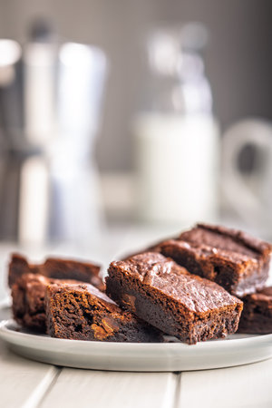 Homemade chocolate brownies on a plate on a white table.の写真素材