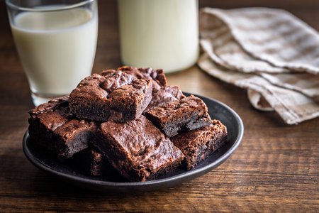 Homemade chocolate brownies on a plate on a wooden table.の写真素材