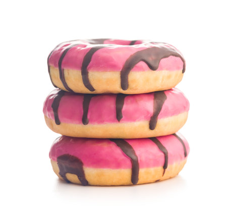 Sweet pink donut with chocolate strips isolated on a white background.の写真素材