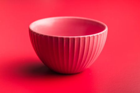 Empty red bowl on a red background.の写真素材