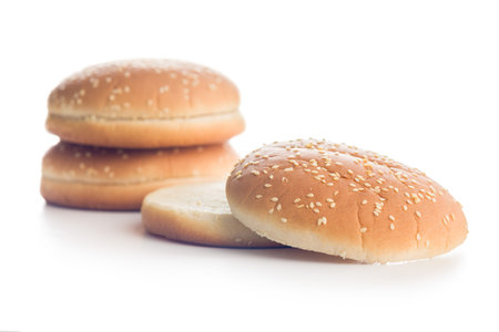 Empty burger bun with sesame seeds isolated on a white background.の写真素材