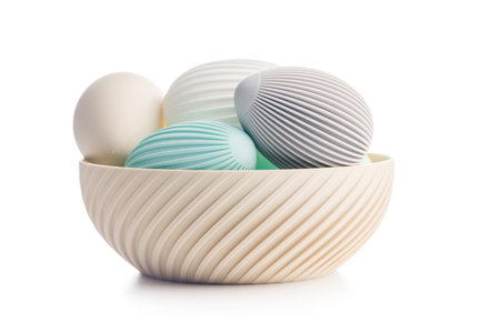 Easter decorations. Colorful eggs in a bowl isolated on a white background.の写真素材