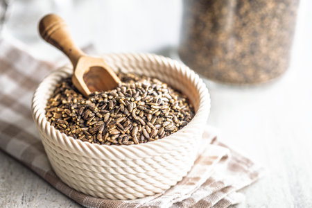 Milk thistle seeds in a bowl on a kitchen table.の写真素材