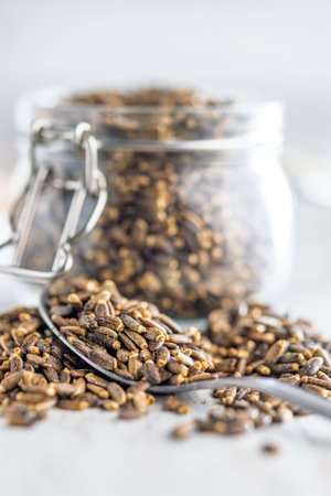 Seeds in spoon on a kitchen table.の写真素材