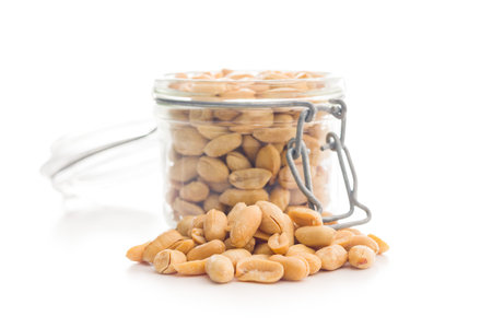 Roasted salted peanuts in a jar isolated on a white background.の写真素材