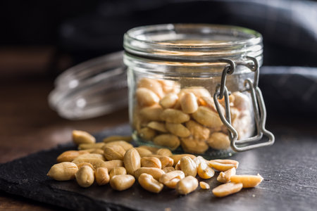 Roasted salted peanuts in a jar.の写真素材