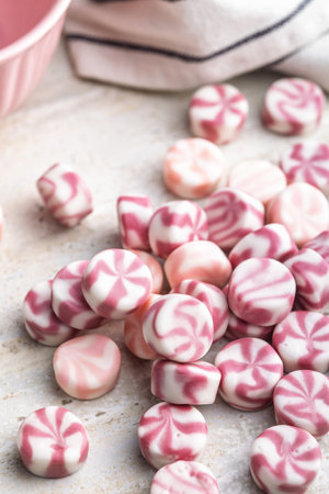 Colorful striped candies on a kitchen table.の写真素材