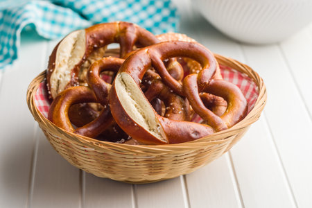 Salted pretzel in basket on a kitchen table.の写真素材