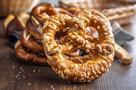 Salted bavarian pretzel on a wooden table.の写真素材
