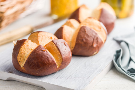 Crunchy buns on a cutting board on a kitchen table.の写真素材