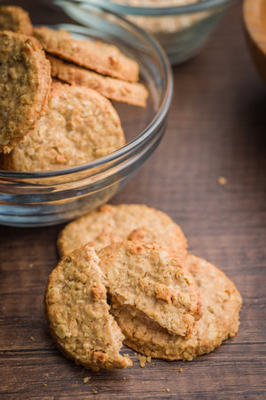 Sweet oatmeal cookies on a wooden table.の写真素材