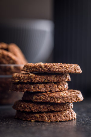 Sweet oatmeal cookies on a black table.の写真素材
