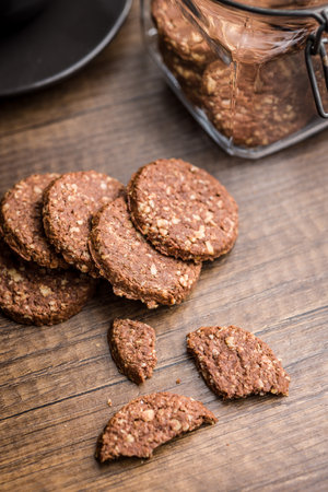 Sweet oatmeal cookies on a wooden table.の写真素材