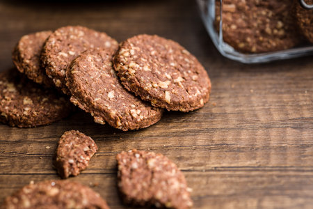 Sweet oatmeal cookies on a wooden table.の写真素材