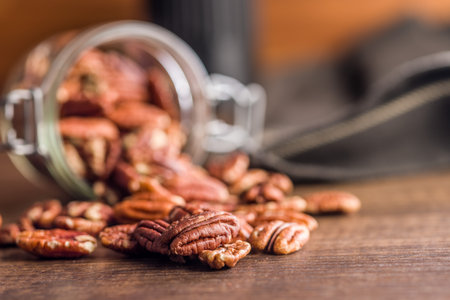 Peeled pecan nuts on a wooden table.の写真素材