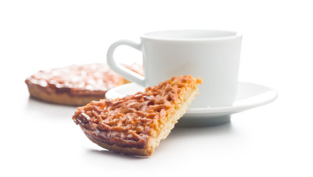 Sweet almond pie and coffee cup isolated on a white background.の写真素材