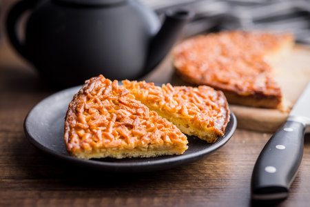 Sweet almond pie on a plate on a wooden table.の写真素材