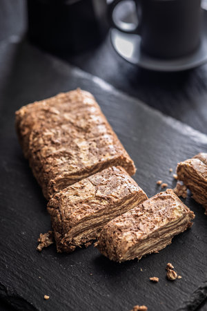 Halva with cocoa. Sweet oriental dessert on a black table.