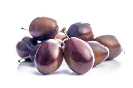 Ripe plums isolated on a white background.の写真素材