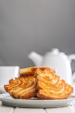 Le sfoglie. Crispy sweet pastry on a plate on a white table.の写真素材