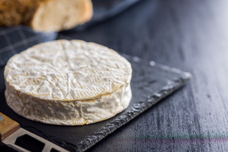 Camembert cheese on a black table.の写真素材