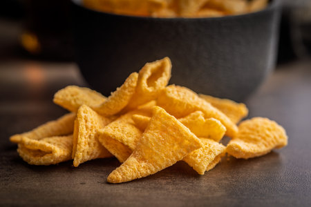 Bugles snack. Cone corn chips on a kitchen table.