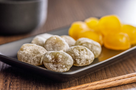 Japanese mochi dessert on a plate on a wooden table.の写真素材