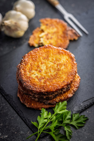 Fried potato pancake on a black table.の写真素材
