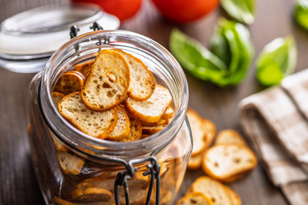 Crispy roasted bruschetta bread in a jar on a wooden table.の写真素材