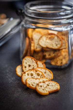 Crispy roasted bruschetta bread on a black table.の写真素材