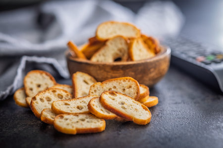 Crispy roasted bruschetta bread on a black table.の写真素材