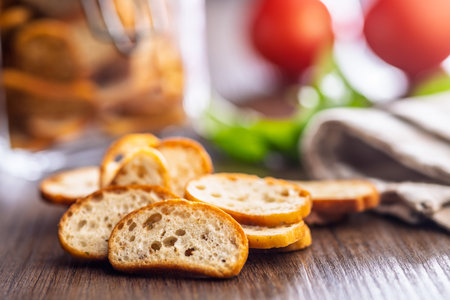 Crispy roasted bruschetta bread on a wooden table.の写真素材