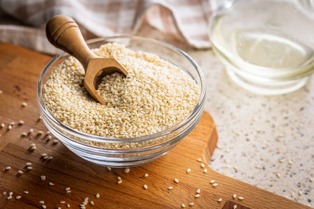 Roasted sesame seeds in a bowl on a cutting board.の写真素材