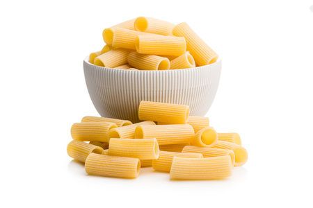 Uncooked rigatoni pasta isolated on a white background.の写真素材