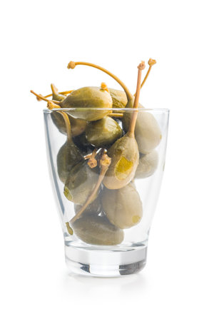 Pickled capers berries in glass isolated on a white background.の写真素材