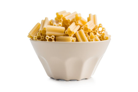 Uncooked italian pasta in a bowl isolated on a white background.の写真素材