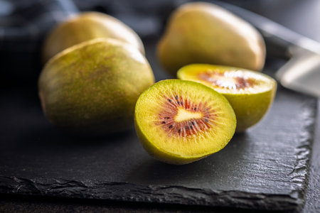 Red kiwi fruit on a black table.の写真素材