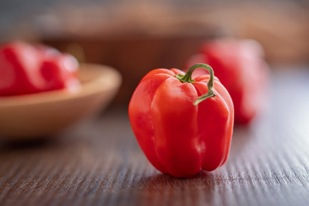 Red chili pepper habanero on a wooden table.の写真素材