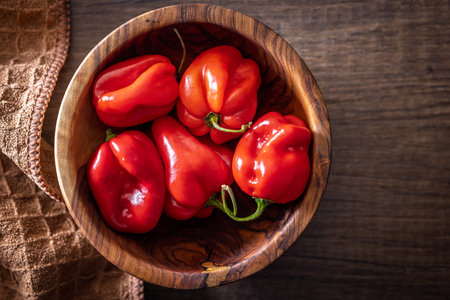 Red chili pepper in bowl on a wooden table. Top view.の写真素材